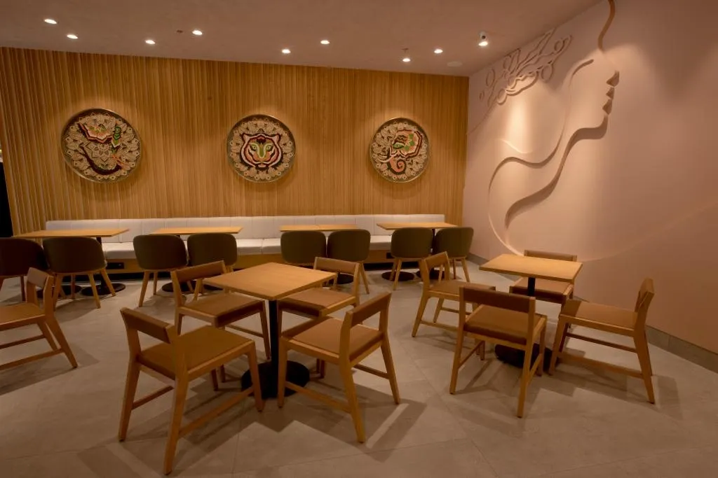Embroidered mandala plates and a carved wall silhouette at Starbucks Model Town, Jalandhar